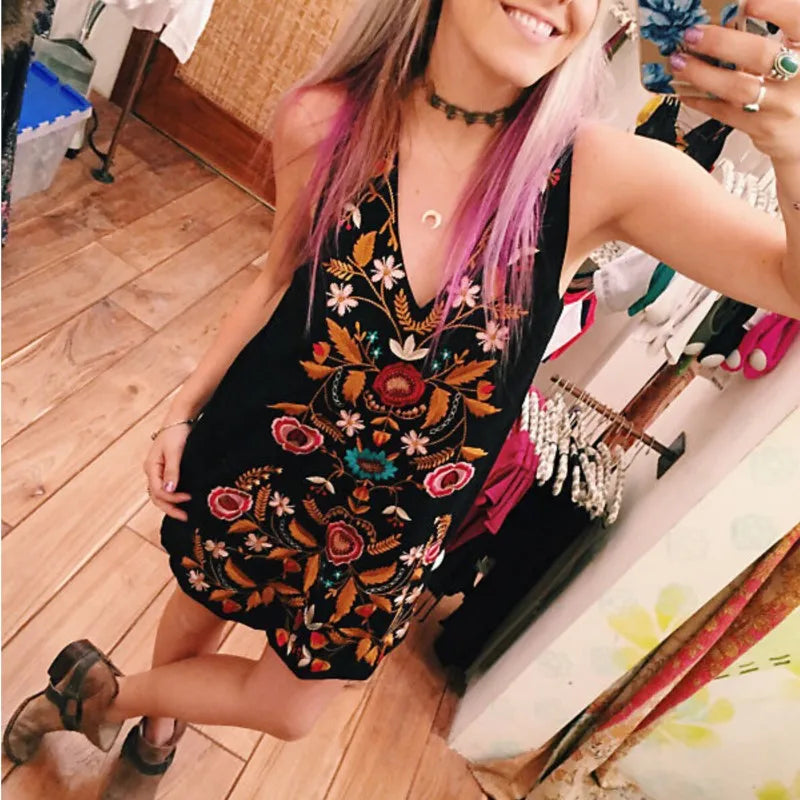Black floral embroidered mini dress styled for festival fashion