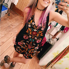 Black floral embroidered mini dress styled for festival fashion