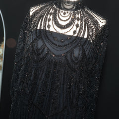 Black beaded garment on a black background