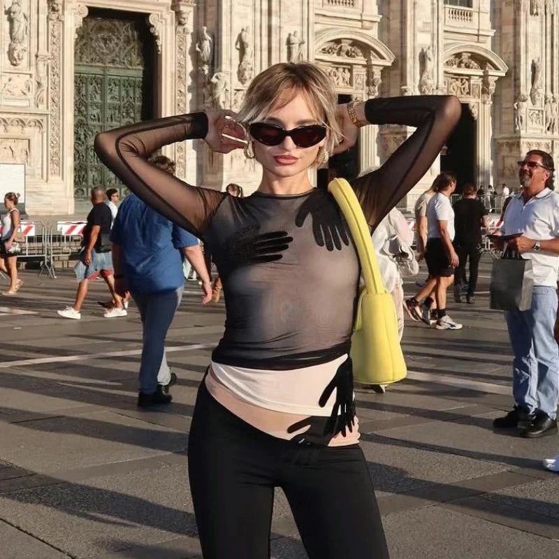 Close crop showing the graphic hand patchwork on the sheer mesh bodice, highlighting the semi-transparent finish and clean O-neckline.