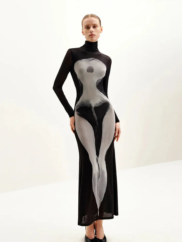 Model wearing a black and gray illusion print mesh maxi dress with turtleneck  on a white background