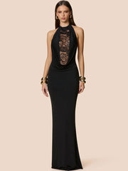 Model wearing a black halter maxi dress with a lace plunge neckline, styled with gold bangles against a soft beige studio background.