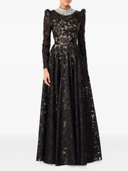Black floor-length maxi dress with stand neckline and long sleeves, featuring embroidered texture and a fitted bodice before a flowing skirt.