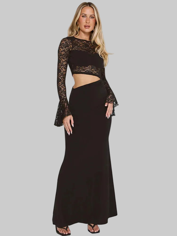 Model wearing a black lace long-sleeve top with a floor-length skirt, featuring a sleek cut-out waist against a light studio backdrop.