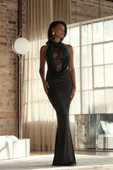 Full-length view highlights the sleek floor-length skirt and clean halter frame, with lace detail drawing focus to the neckline.