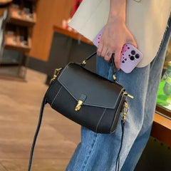 Brown cow leather handbag with zip top and clean stitching along the edges