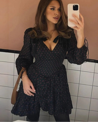 Black polka dot tie mini dress with long sleeves styled for casual city selfies