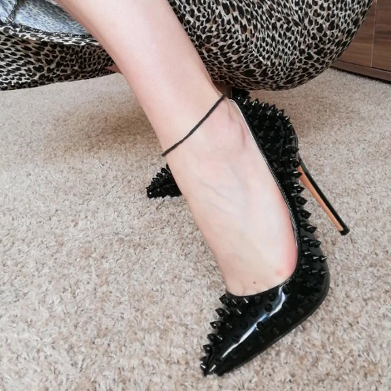 Black rivet spike pumps with pointed toe and thin high heel