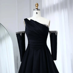 Black satin one-shoulder gala dress shown for wedding and formal events with embellishments on a mannequin against a white curtain background