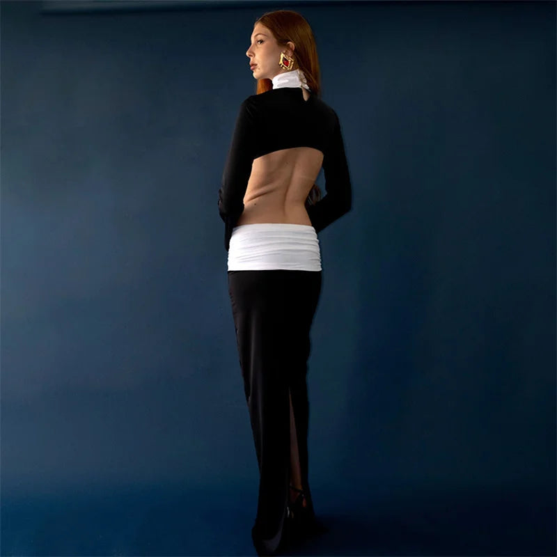 Back pose highlighting the turtleneck line, clean shoulders, and streamlined sleeves for a sharp, minimalist evening look.
