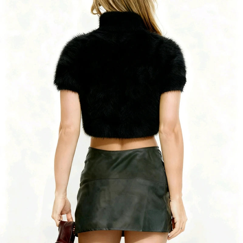 Back view of a black shaggy knit cropped pullover top on a plain background