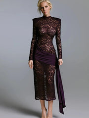 Sheer black lace long sleeve maxi with a clean round neckline, styled against a gray studio backdrop with a sculpted, elongated fit.