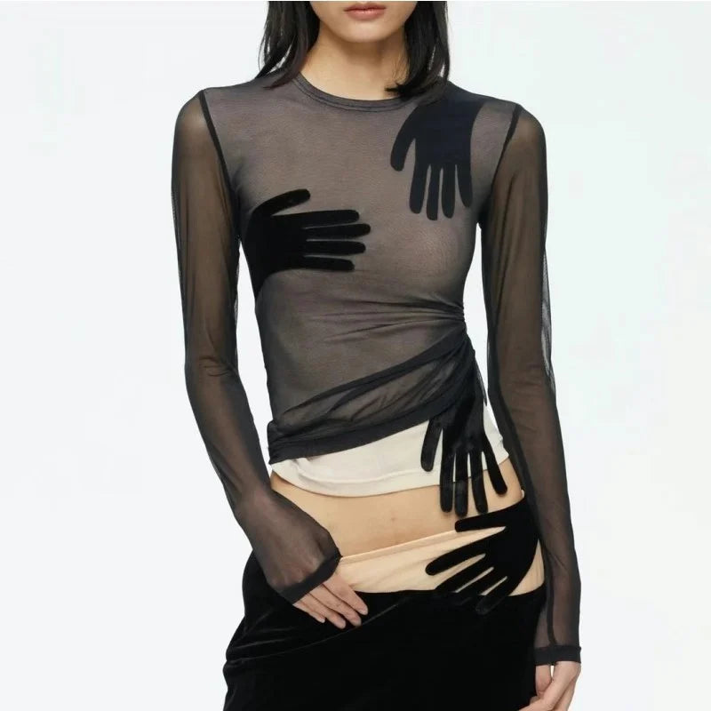 Sheer black top with black gloves and a white skirt on a white background