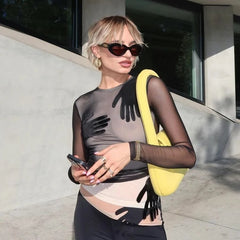 Detail view of the sheer sleeve and hand-motif placement, showing the lightweight mesh texture and smooth, close-to-body fit.