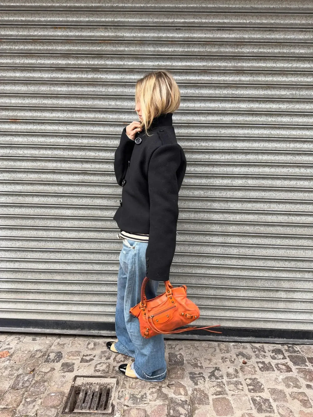 Structured short coat styled with denim for a polished look