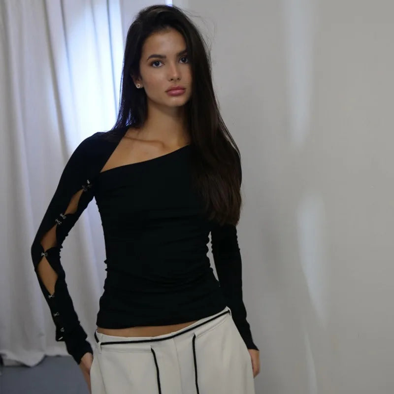 Front view of a black skew-neckline long sleeve tee showing smooth stretch fit and sculpted shoulder line in indoor lighting.
