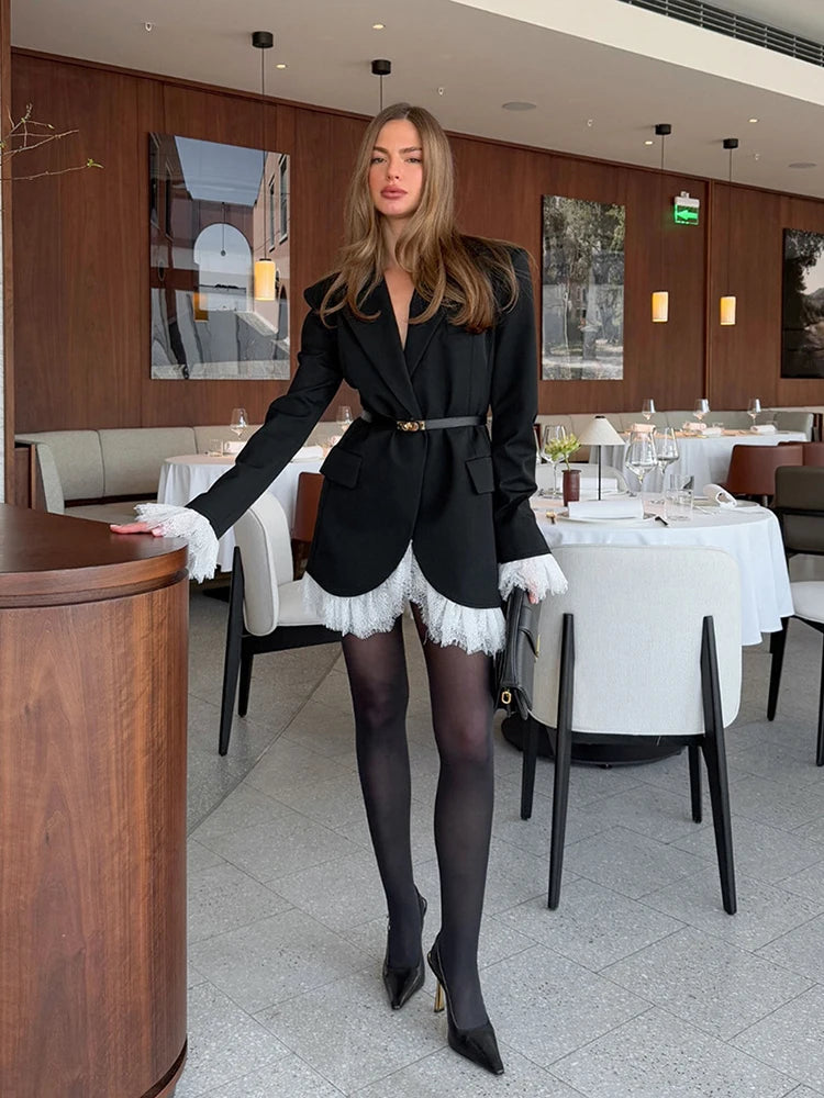 Outfit styling view in a modern room setting, showing the slim single-button blazer coat paired with a small handbag for evenings.