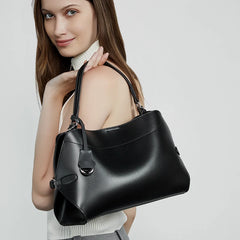 Black split leather shoulder bag with a soft structured silhouette