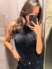 Front view highlighting the halter neckline and rippled texture on a black tank top designed to skim the body.