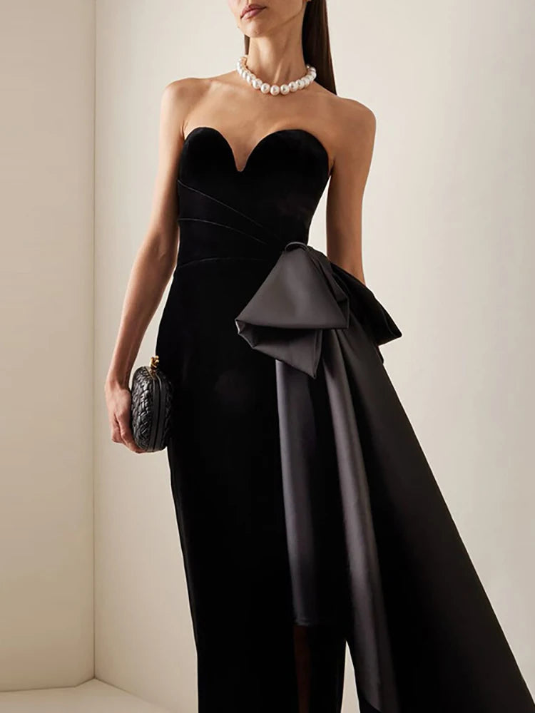 Black velvet strapless bow dress styled for evening wear