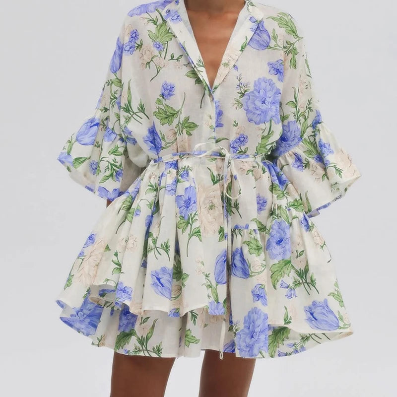 Blue floral print lace-up mini dress styled for office or brunch in autumn on a plain background