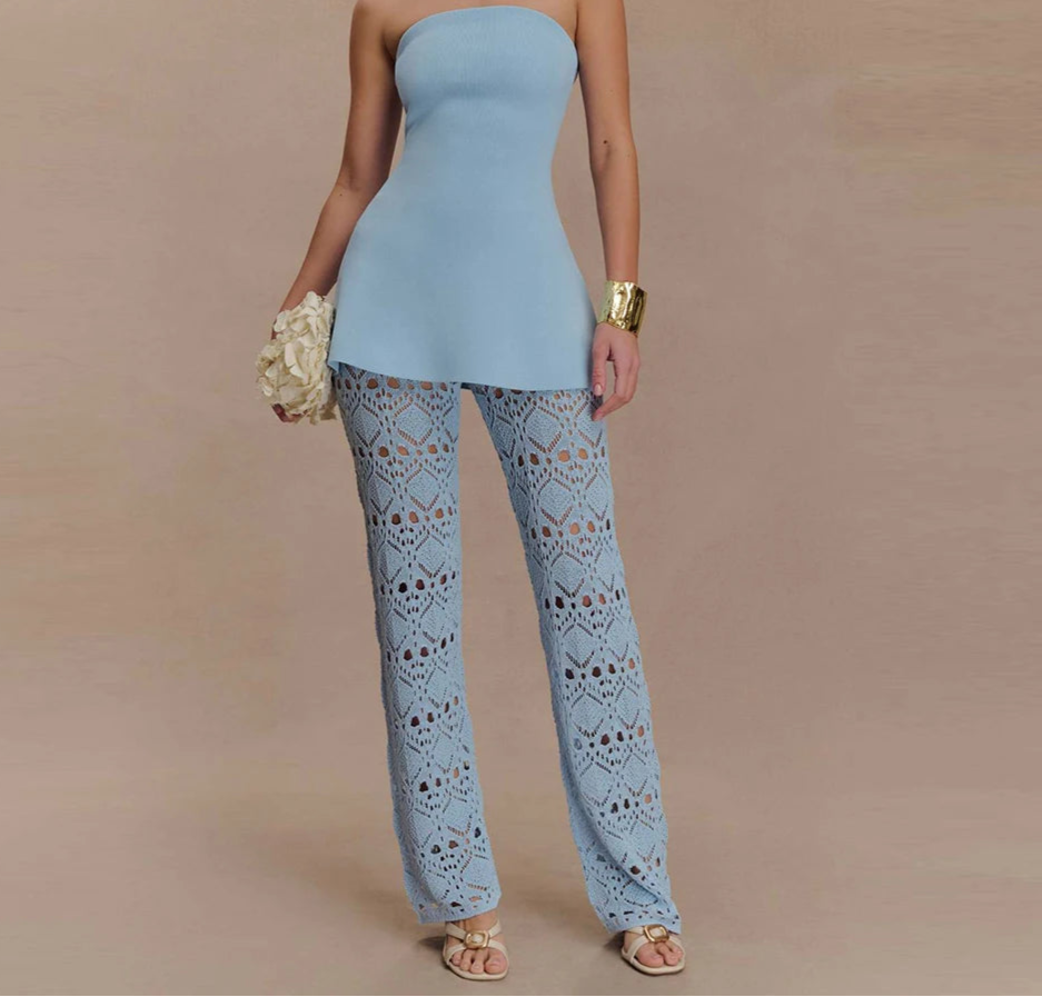 Woman wearing a blue strapless lace pants set styled with gold accessories