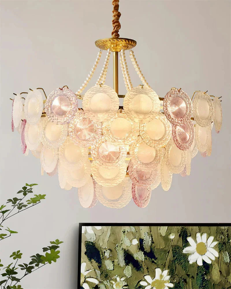 Blush glass stone chandelier with gold accents in a modern interior