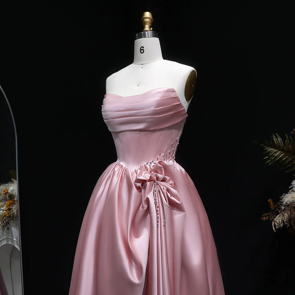 Close-up of pleated strapless satin bodice with beading accent