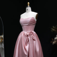 Close-up of pleated strapless satin bodice with beading accent