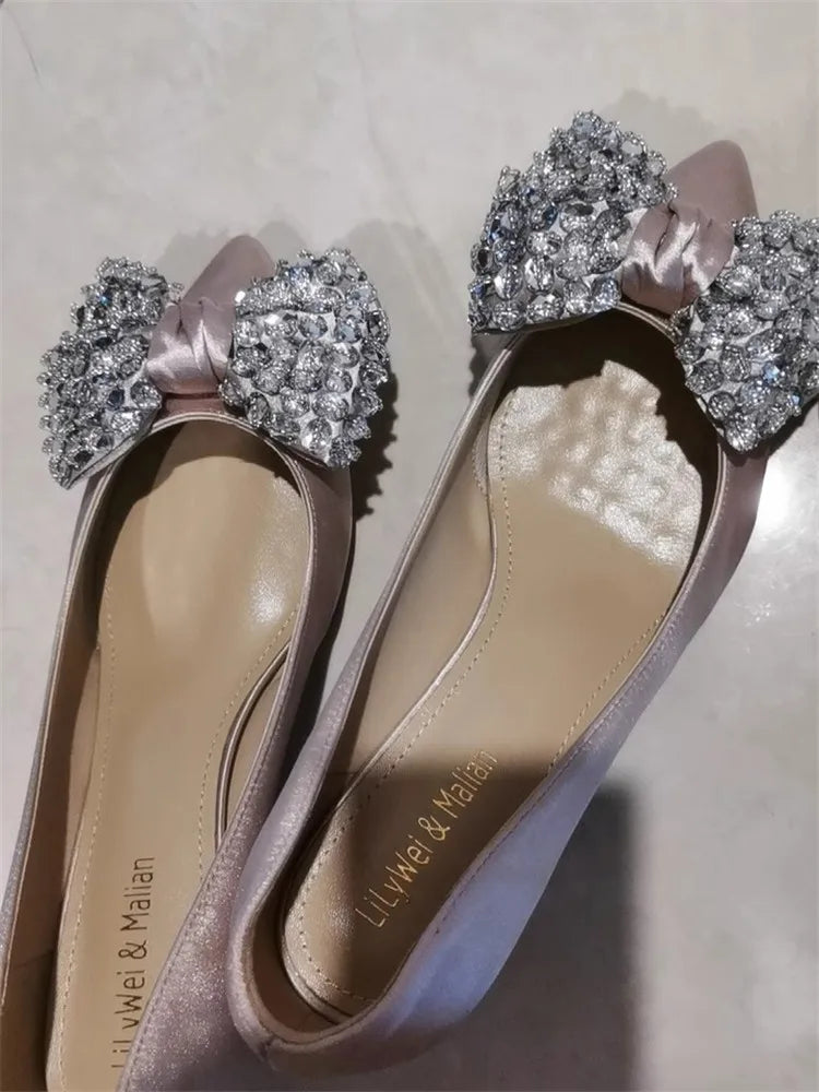 Blush pink rhinestone bow high heel styled for bridal and party events on a light background