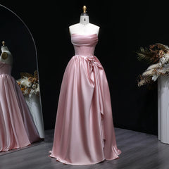 Strapless draped satin A-line prom gown with beaded detail on mannequin