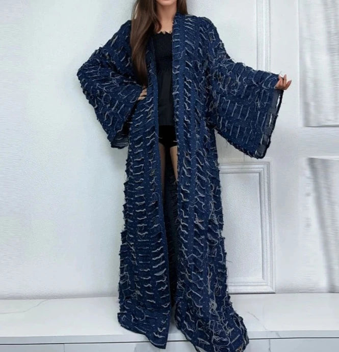 Woman wearing long bohemian tassel denim coat