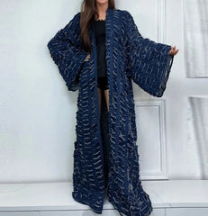 Woman wearing long bohemian tassel denim coat