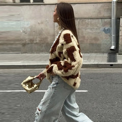 Western-inspired cow print sweater layered for creative autumn outfits