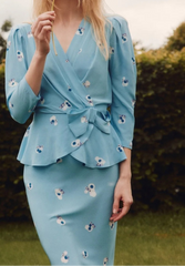 close view of bow-knot peplum waist on floral wrap blouse