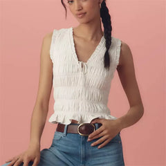A close-up of the bow tie detail on the V-neck top.