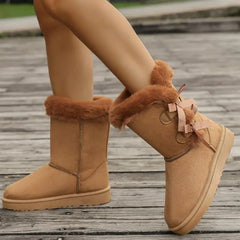 Front view of bowknot plush mid-calf snow boots for women