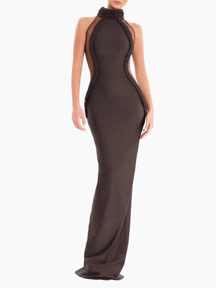 Woman wearing brown halter-neck mesh patchwork sheath maxi evening dress, floor-length, sleeveless, on white background.