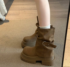Brown platform buckle ankle boots worn indoors