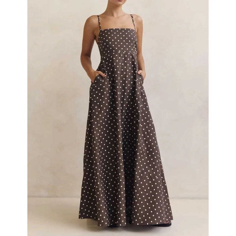 Front view of a brown polka dot maxi dress with square neckline and spaghetti straps, styled simply against a neutral studio backdrop.