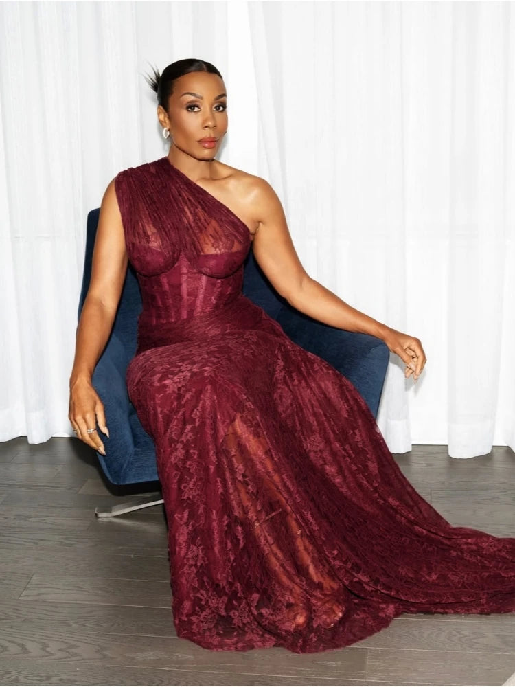 Detail view of the gathered drape at the waist and hip, emphasizing the fold construction and sleek sheath silhouette.