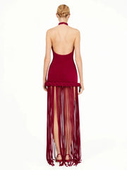 Three-quarter view showing the slim sheath fit through the waist and hips, with tassels adding a bold, runway-style finish.