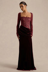 Full-length view showing a burgundy long sleeve evening gown with a fitted lace top and smooth velvet skirt for a sleek silhouette.