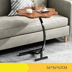 C-base side table positioned close to a sofa seat