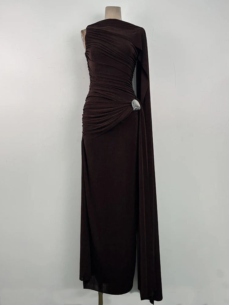 Three-quarter angle emphasizing the one-side cape detail and clean high neckline, styled minimally for a black-tie-leaning evening look.