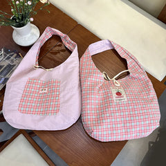 Two reversible plaid vest bags with cartoon tomato print