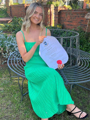 Stretch ribbed knit midi dress styled with clutch bag