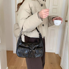 Casual black biker-style handbag with zipper closure

