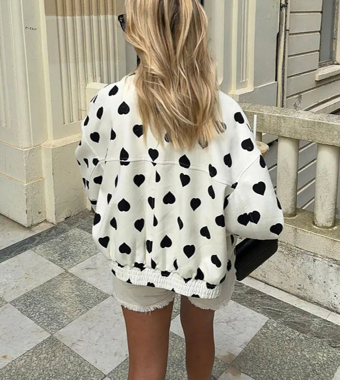 The jacket styled with jeans for a comfortable and chic winter streetwear look.