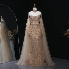 Elegant evening gown with sheer sleeves on a mannequin against a dark background